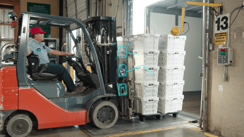 photo of person driving machinery carrying crates