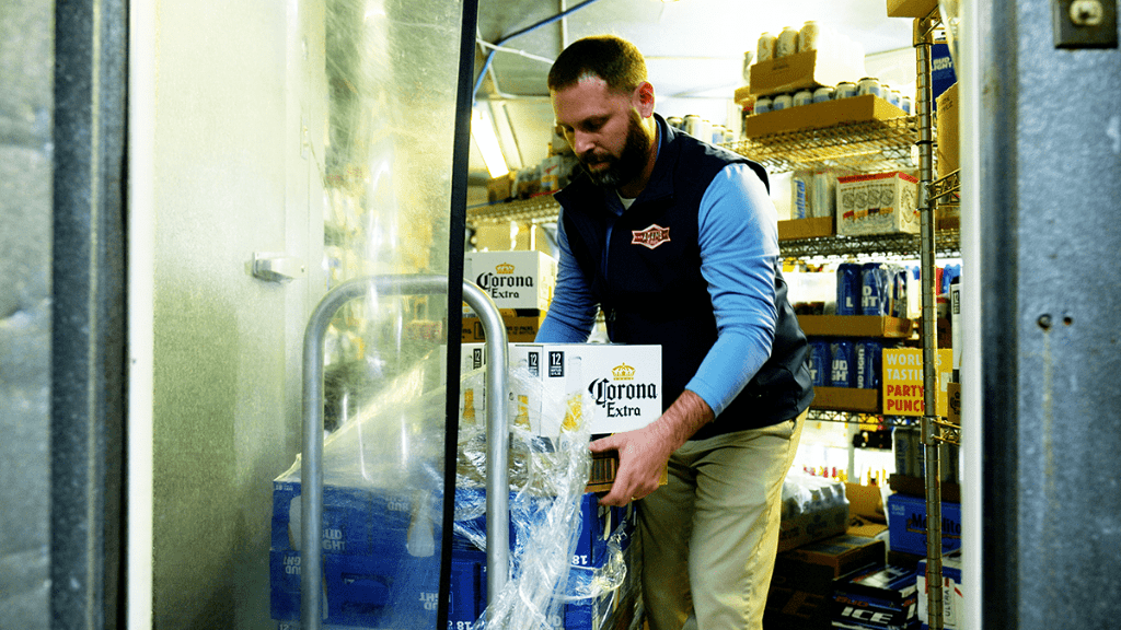 A-Photo-Of-A-Delivery-Driver-Unloading-Beer-Pallet-In-Convenience-Store-Cooler